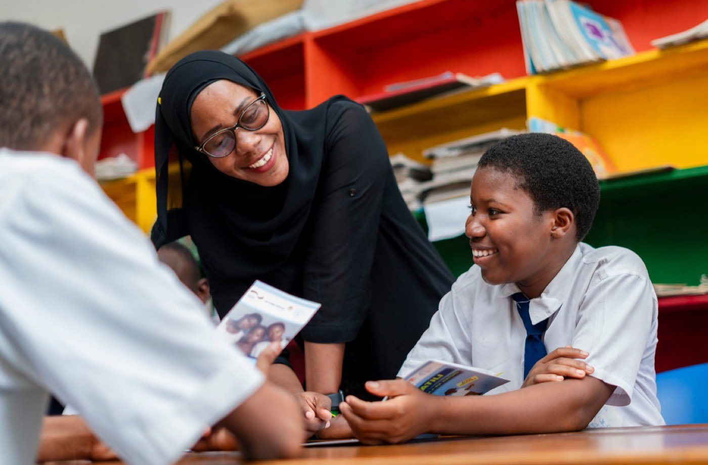 A teacher guiding students in a classroom